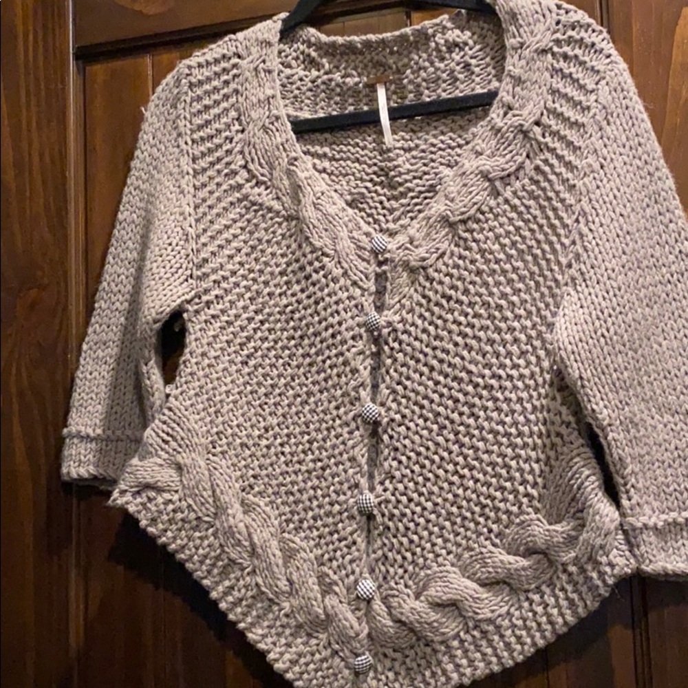 Unique open knit sweater with gingham buttons.